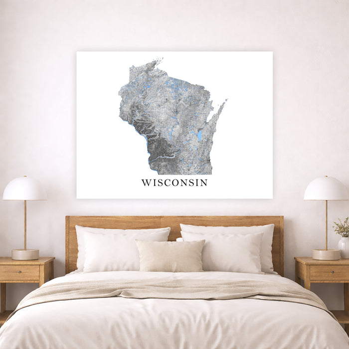 Map of Wisconsin on a wall above a bed in a bedroom setting
