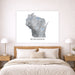 Map of Wisconsin on a wall above a bed in a bedroom setting