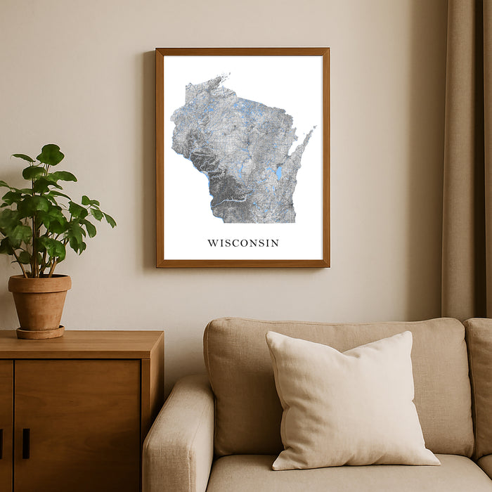 Framed map of Wisconsin on a wall above a beige sofa with a plant beside it.