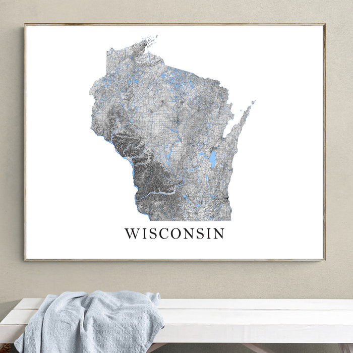 Framed map of Wisconsin on a wall above a white bench.