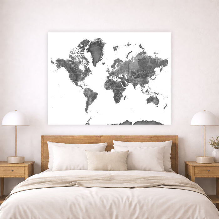 World map poster above a bed in a bedroom setting