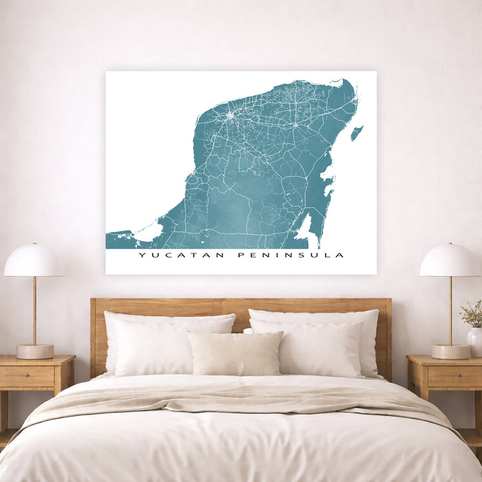 Map of Yucatan Peninsula on a wall above a bed in a bedroom.