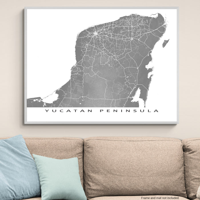 Framed map of Yucatan Peninsula on a wall above a sofa
