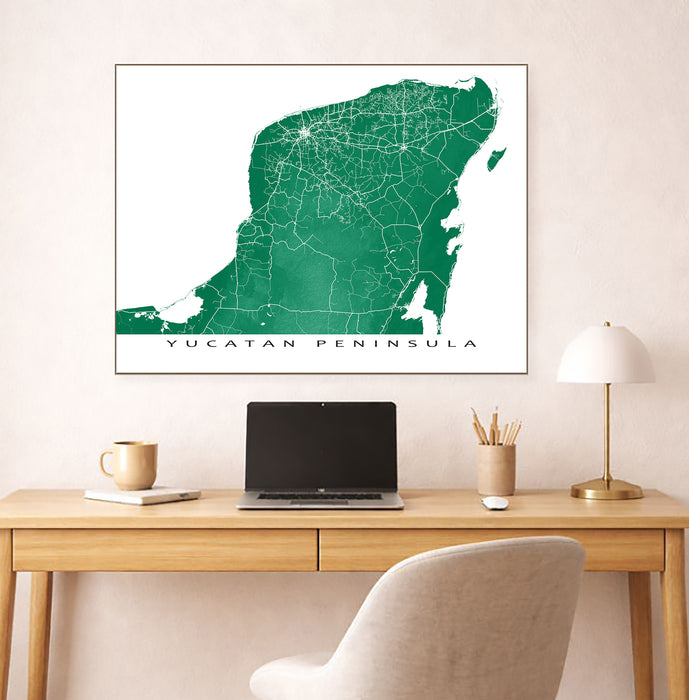 Map of Yucatan Peninsula on a wall above a desk with a laptop and office items.