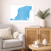 Living room with a map of Yucatan Peninsula on the wall, a couch, and a side table with decor items.