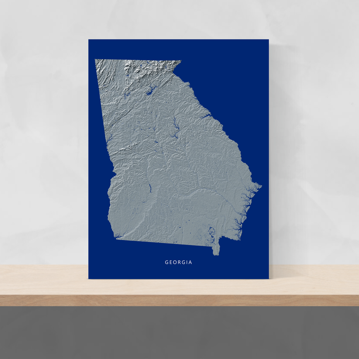 Georgia state map print with natural landscape in greyscale and a navy blue background designed by Maps As Art.