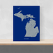 Michigan state map print with natural landscape in greyscale and a navy blue background designed by Maps As Art.