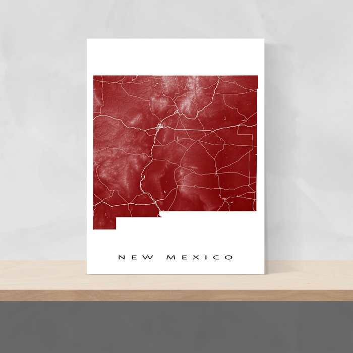 New Mexico state map print with natural landscape and main roads in Merlot designed by Maps As Art.