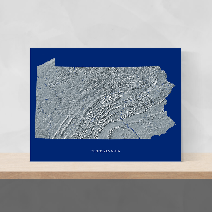 Pennsylvania state map print with natural landscape in greyscale and a navy blue background designed by Maps As Art.