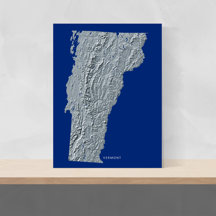 Vermont state map print with natural landscape in greyscale and a navy blue background designed by Maps As Art.
