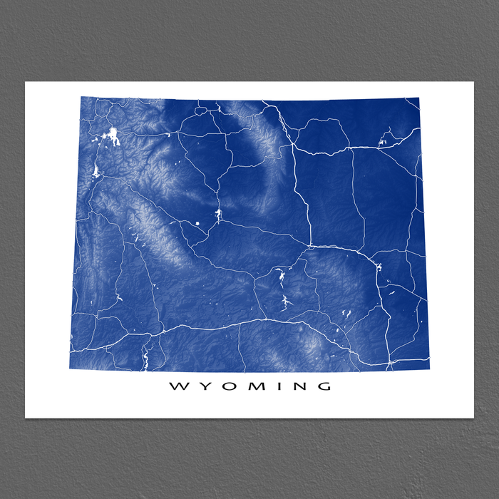 Wyoming map print with natural landscape and main roads in Navy designed by Maps As Art.